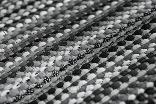 background, texture of colored handmade carpet. Fabric rug of small patches