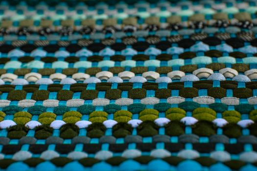 background, texture of colored handmade carpet. Fabric rug of small patches