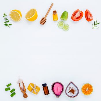 Homemade skin care and body scrubs with natural ingredients aloe vera ,lemon,cucumber ,himalayan salt ,tomato,mint ,lime slice,rosemary and honey set up on white wooden background with flat lay.