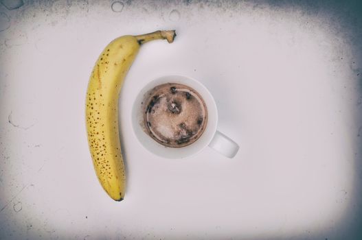 Complete protein Hot Chocolate drink and a banana, isolated on white, overhead shot