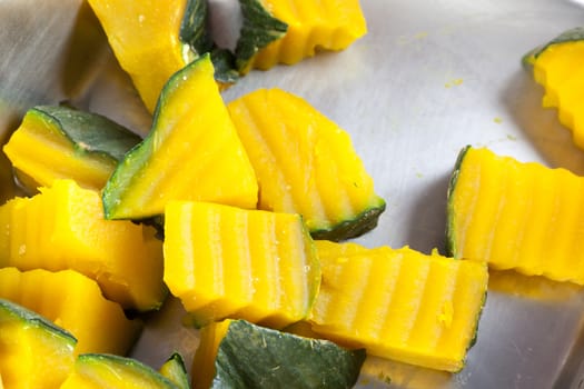 Slices of boiled pumpkin on stainless steel trays