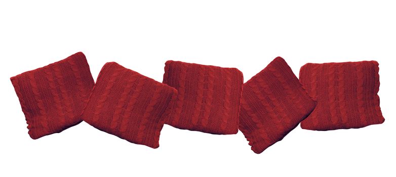 red knitted pillows isolated on white background.