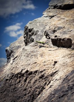 Dreamy background Anchor climbing on a rock wall