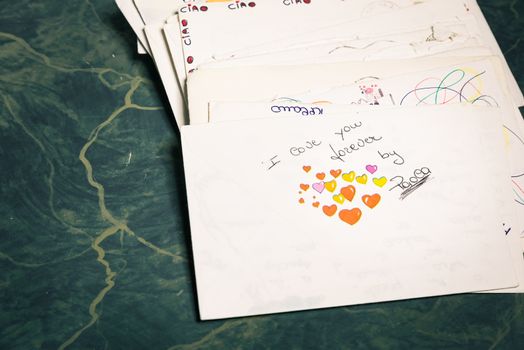 Big stack of mails, pile of papers, or heap of letters, above a letter saying "I love you forever ...".