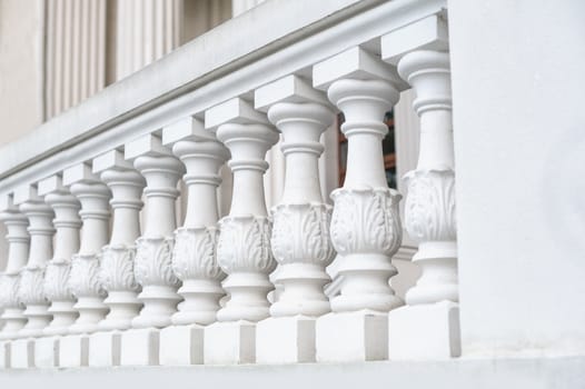 White balustrade on the restored facade of the building.