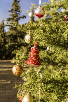 Decorated Christmas tree in the forest at nature background.