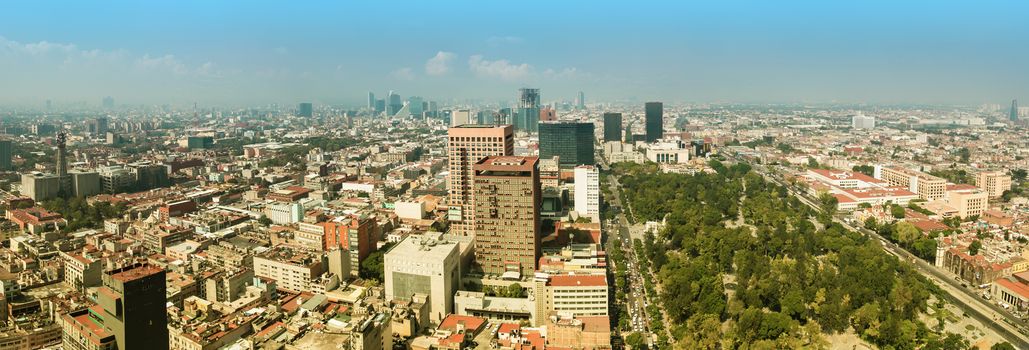 Aerial panorama of Mexico City on a sunny morning with Central Alameda Park on the right. Mexico City is a capitol of Mexico. The camera is pointed to the west.