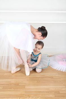 Teen dancer and toddler in costume at dance studio