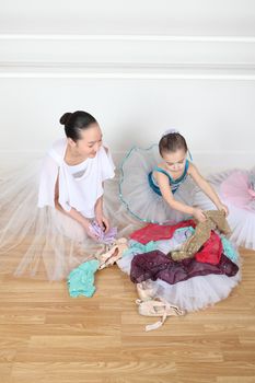 Teen dancer and toddler in costume at dance studio