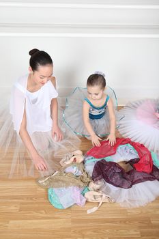 Teen dancer and toddler in costume at dance studio