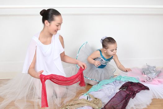 Teen dancer and toddler in costume at dance studio