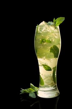 Mint jelly with leaves and ice on a black background.