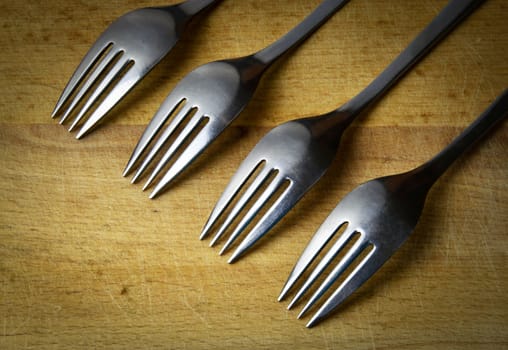 background four forks obliquely on wood