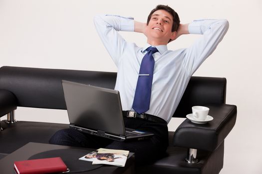 Young businessman in a suit on isolated background
