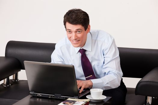 Young businessman in a suit on isolated background
