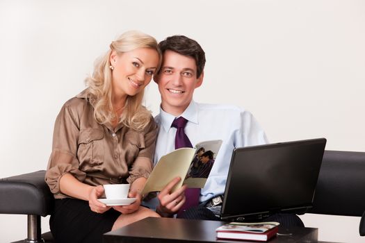 Young woman and man working at the notebook