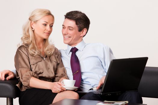 Young woman and man working at the notebook