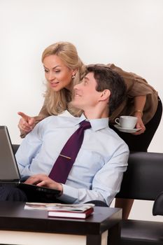 Young woman and man working at the notebook