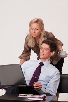 Young woman and man working at the notebook