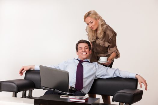 Young woman and man working at the notebook