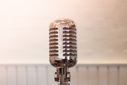 Vintage silver microphone with blurred background, stock photo