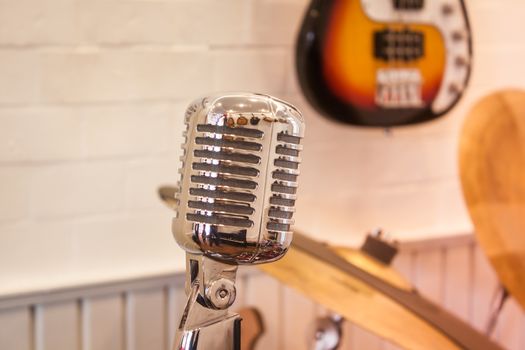 Vintage silver microphone with blurred background, stock photo