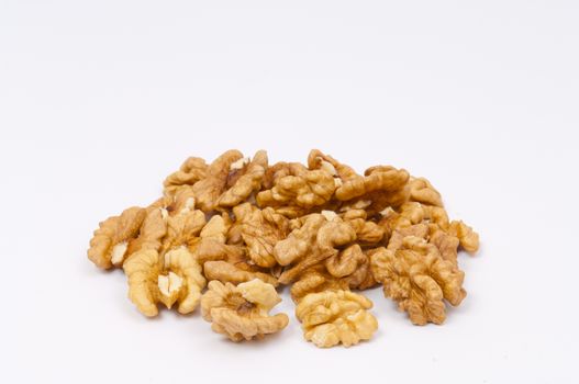 Pile walnut kernels on white background