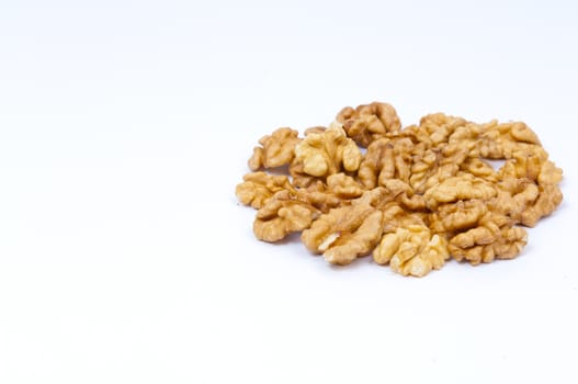 Pile walnut kernels on white background