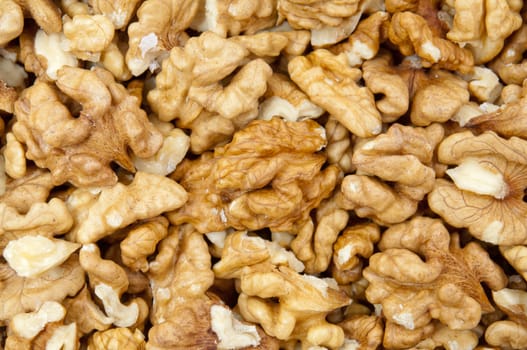 Closeup of shelled walnuts pile as walnut background