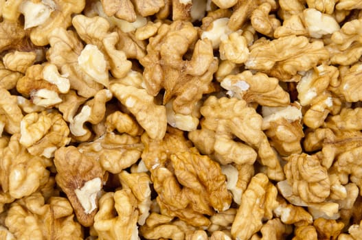 Closeup of shelled walnuts pile as walnut background