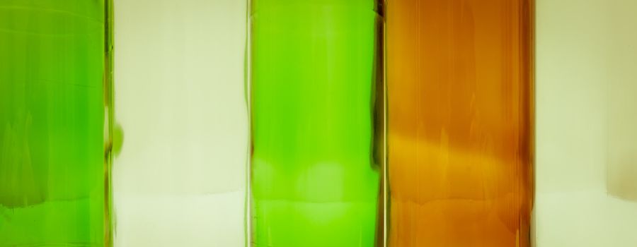 Empty glass bottles of mixed colors including green, clear white, brown