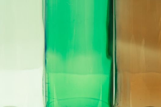 Empty glass bottles of mixed colors including green, clear white, brown