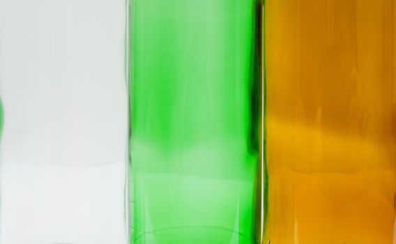 Empty glass bottles of mixed colors including green, clear white, brown