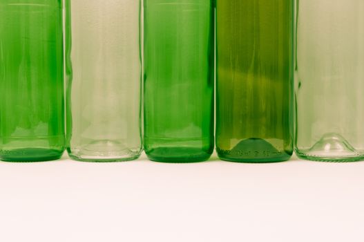 Empty glass bottles of mixed colors including green, clear white, brown