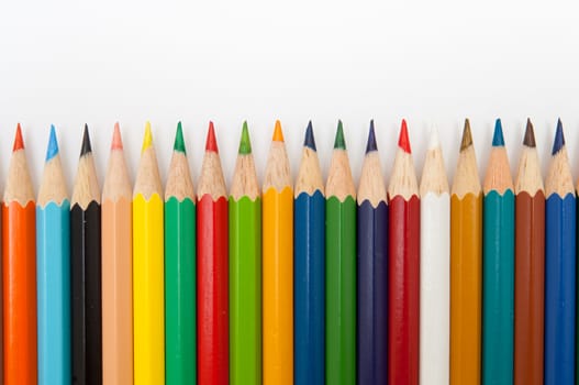 Pattern of color pencils isolated on white background close up