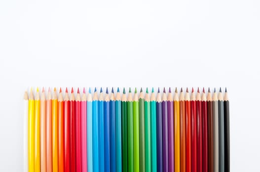 Pattern of color pencils isolated on white background close up