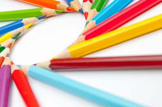 Pattern of color pencils isolated on white background close up