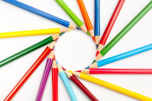 Pattern of color pencils isolated on white background close up