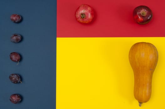 Organic autumn fruits and nuts isolated on split background with copy space