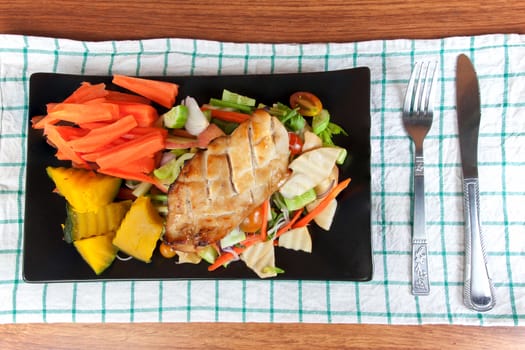 Grilled chicken steak with spices and vegetable on the black dish, Healthy diet meals.