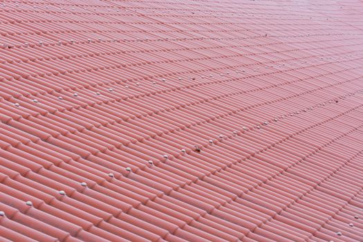 Pattern of a red tile roof of plastic plates.