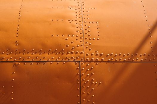 orange texture covering aircraft rivets for background.