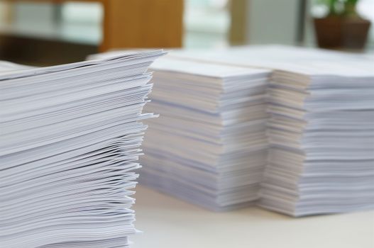 Stack of white papers sheet was organized  on office background.                              