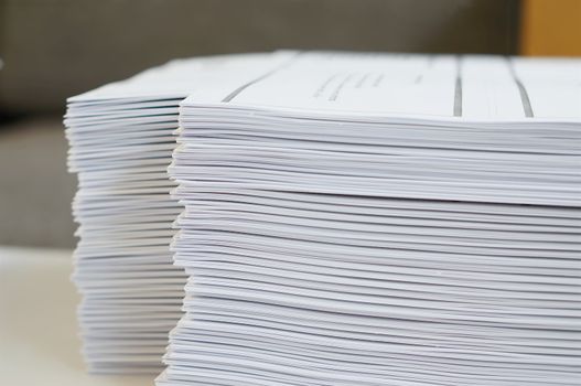 Stack of white papers sheet was organized  on office background.                                