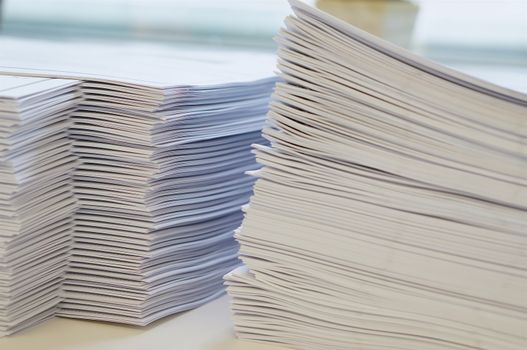 Stack of white papers sheet was organized  on office background.                              