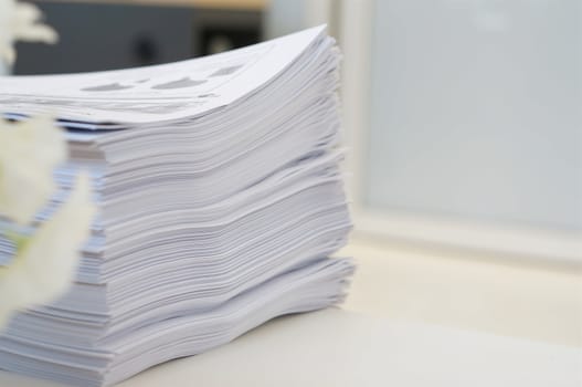 Stack of white papers sheet was organized  on office background.                              