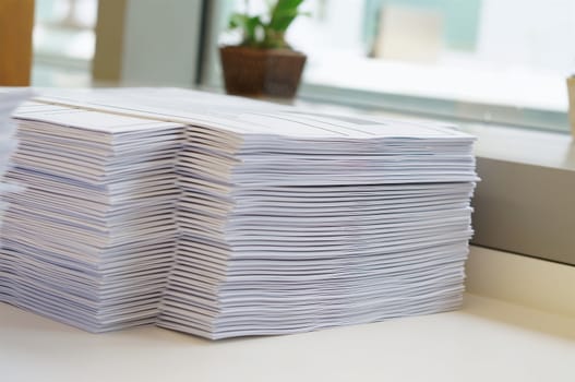 Stack of white papers sheet was organized  on office background.                               