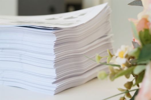 Stack of white papers sheet was organized  on office background.                           
