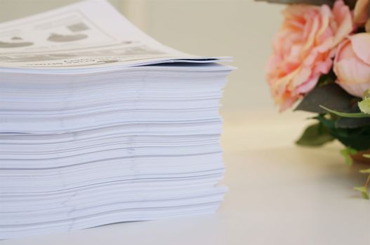 Stack of white papers sheet was organized  on office background.                              