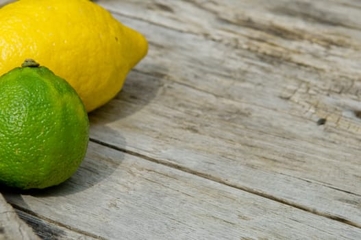 Raw textured wood Background backdrop with lemon and lime and copy space outdoor